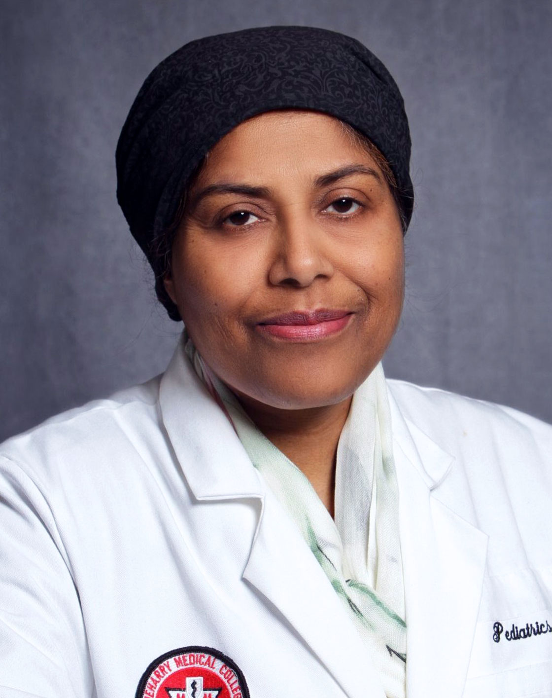Woman in white coat posing for portrait.