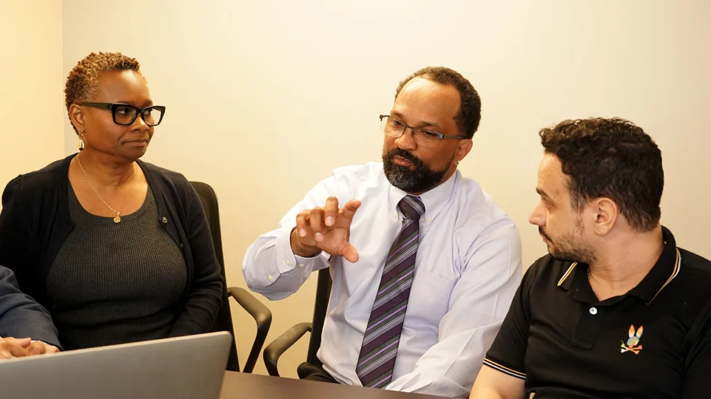 Three staff on EDA team discuss project