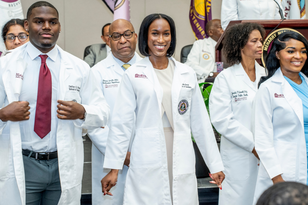 A group of doctors posing together at a formal event.